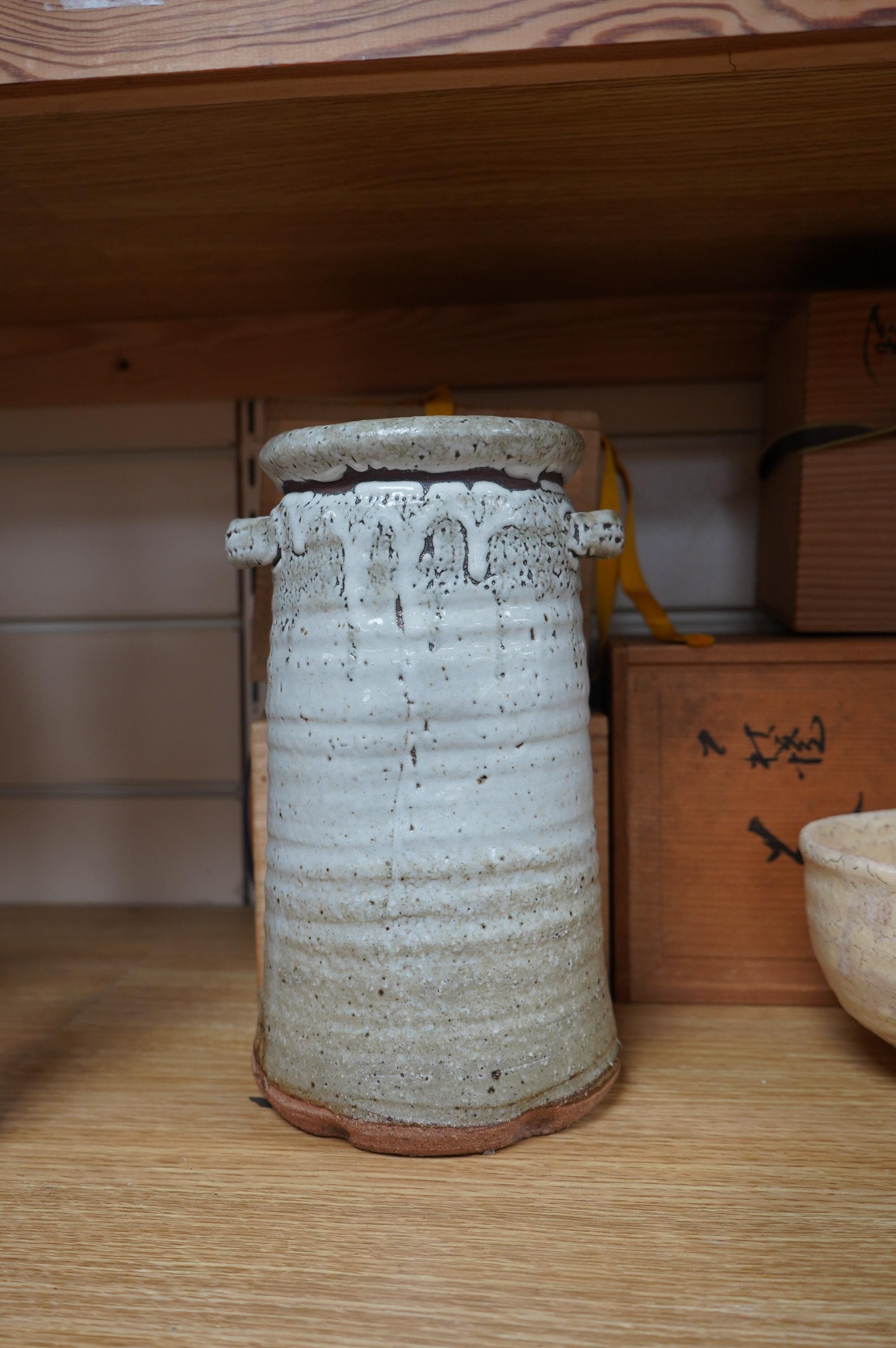 Japanese studio pottery comprising a Nishiyama (Contemporary Japanese School) tea bowl in the Yashichida style decorated with flowers (fitted box), a near pair of Japanese studio pottery cream ground raku bowls (fitted b